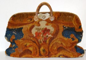 American carpetbag circa 1860; wool with leather handles. ~ Wikimedia.org